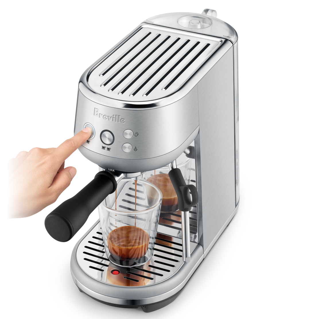 Breville Bambino Espresso Machine with a glass of coffee being poured into it on a white background