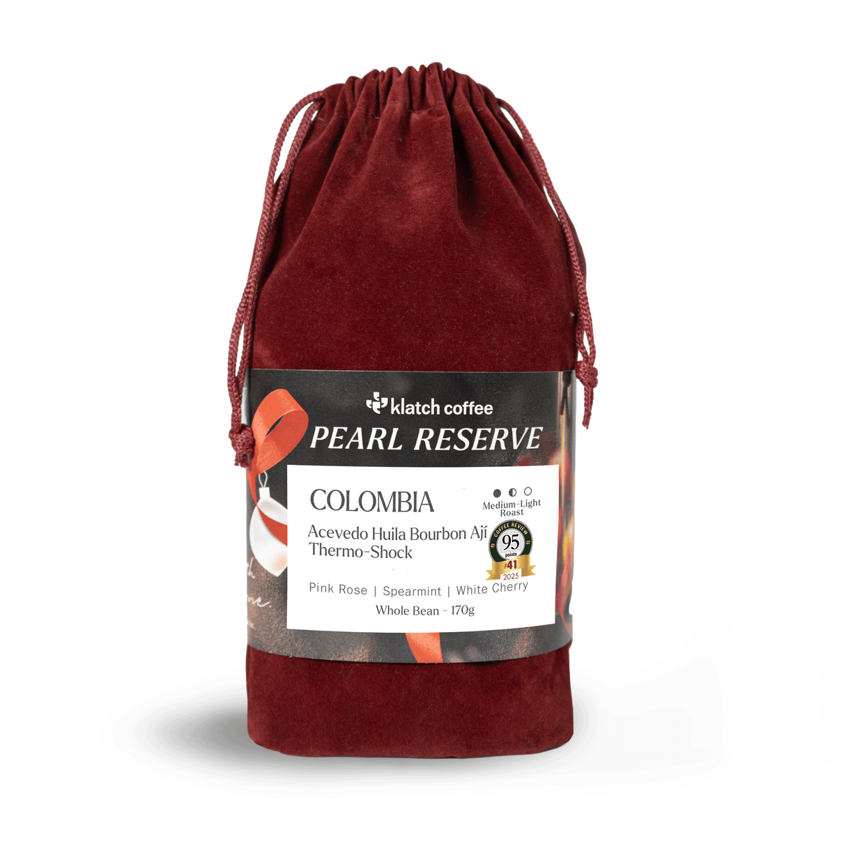 Red velvet drawstring bag with Klatch Coffee Pearl Reserve Colombia label on a white background