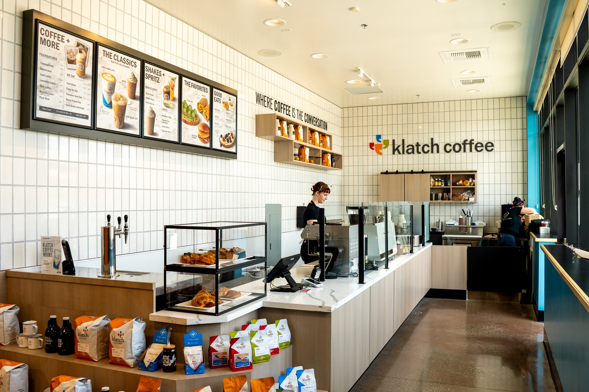 Interior of Klatch Coffee's Fontana, CA location inside Sprouts Farmers Market with a barista behind the counter.