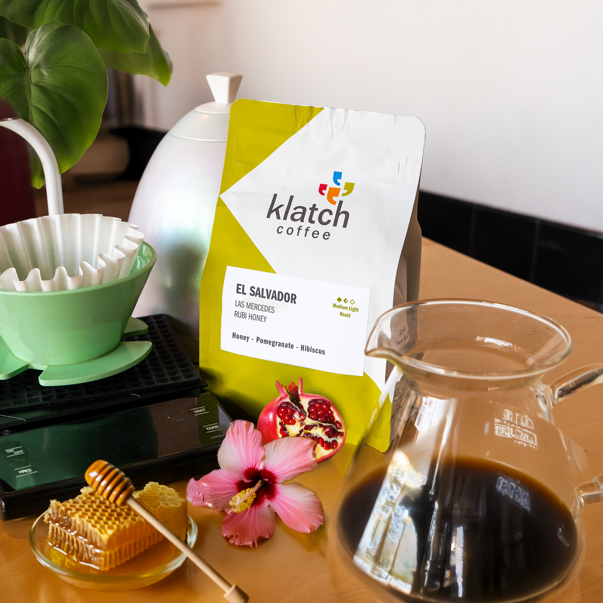 Klatch coffee package with a glass of coffee and honeycomb on a wooden table.