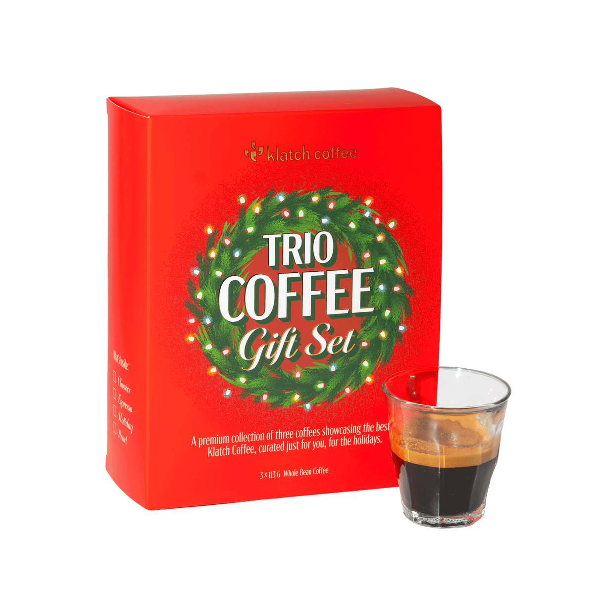 Klatch Coffee Espresso Trio Gift Set in a festive red box featuring a Christmas wreath, displayed beside a shot of espresso on a white background.