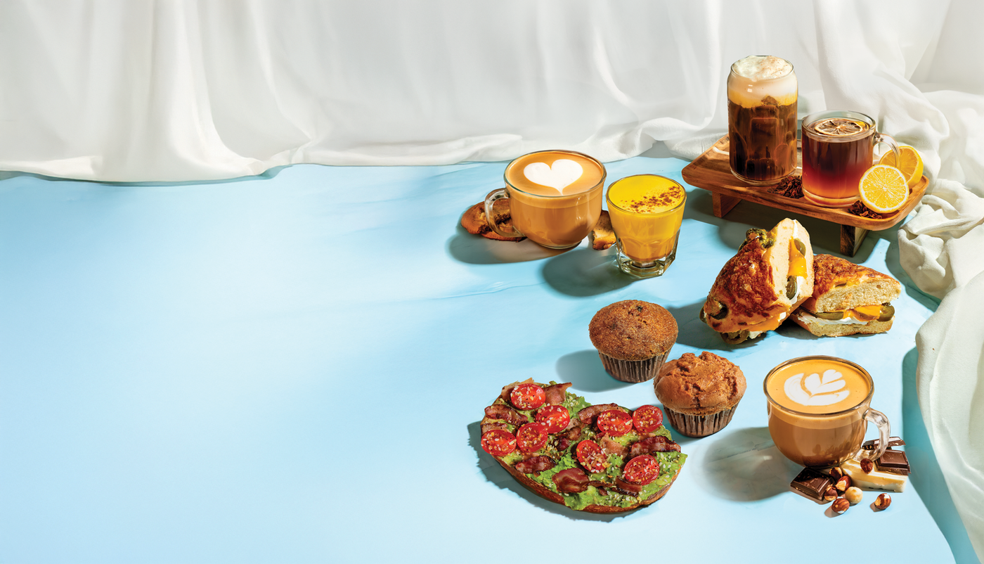 Good for the Body & Soul Menu: Assorted seasonal drinks, items including pastries, and a sandwich on a light blue surface.