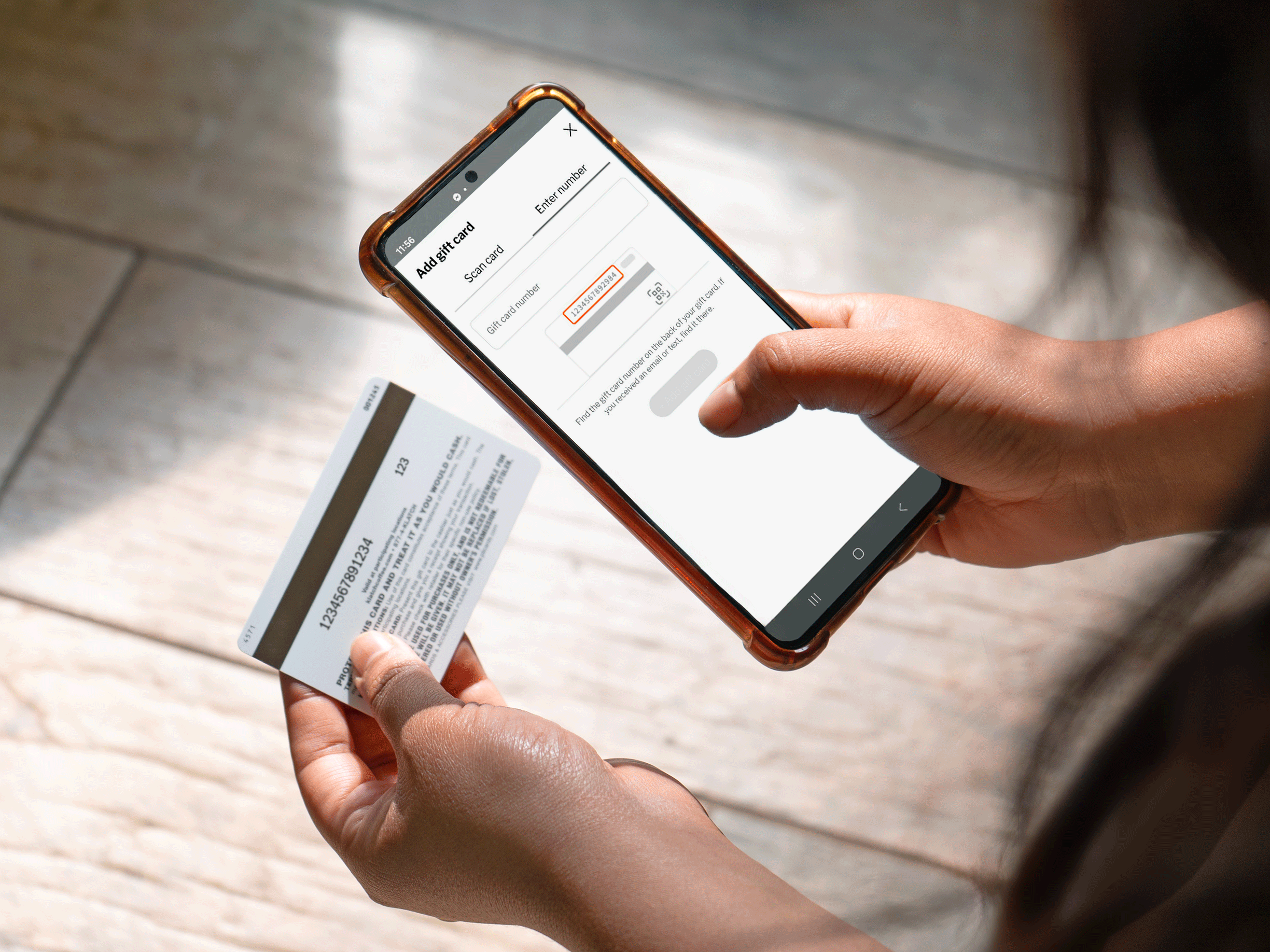 Hand holding a Klatch Coffee gift card and a phone displaying the new Klatch Coffee app.