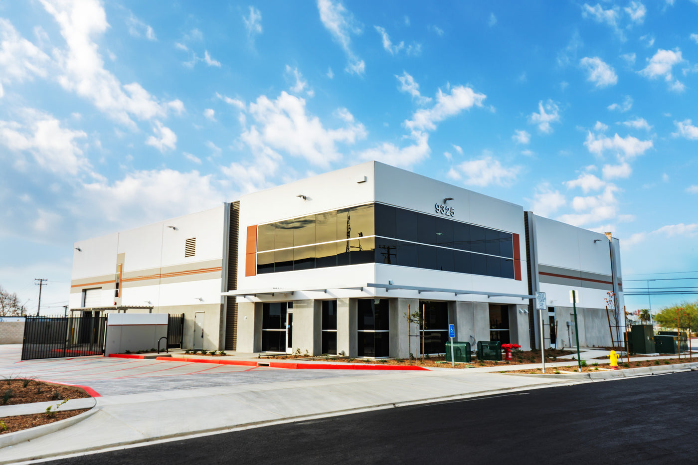 Klatch Coffee Feron Roastery building exterior with blue sky and clouds.
