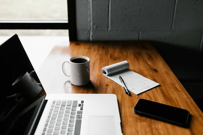 Laptop and coffee mug on a desk