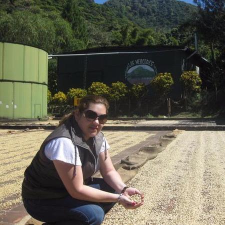 Photograph of a woman holding coffee beans
