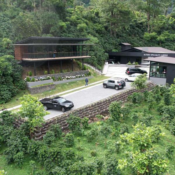 Panama Altieri Specialty Coffee buildings on green hillside.