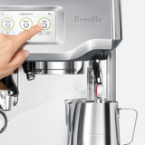 Barista Touch Espresso Machine with a hand pressing a button on the screen panel.