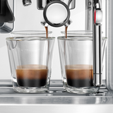 Espresso being poured into two glass glasses from a Barista Touch Espresso Machine.