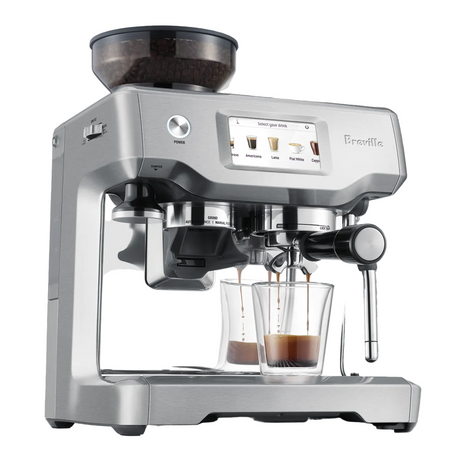 Barista Touch Espresso Machine with shot glass of espresso.