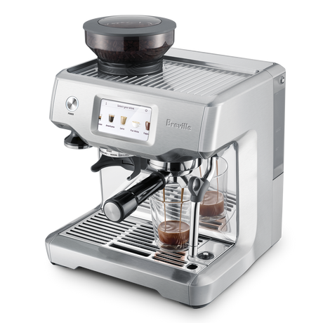 Barista Touch Espresso Machine with shot glass of espresso top 3/4 view