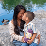 Mother kissing her son’s head by a lake while holding Klatch Coffee’s Black Honey Pearl Reserve Coffee.