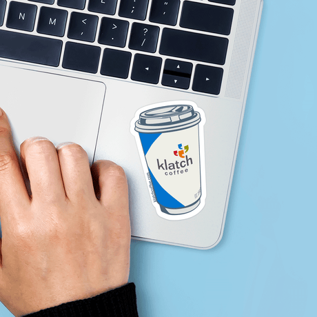Sticker of a coffee cup with 'klatch coffee' on a laptop