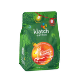 Klatch Coffee Dancing Reindeer holiday coffee bag featuring festive green packaging.