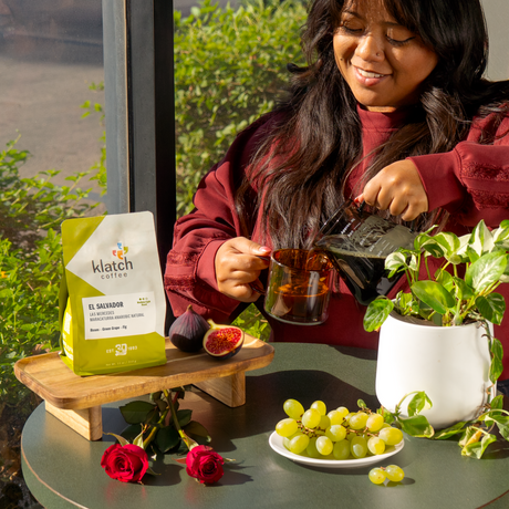 Woman pouring coffee with klatch coffee bag and fruits on a table