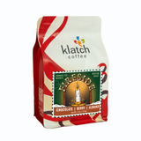 Holiday white and red ribbon graphics on Klatch Coffee 'Fireside' flavor description on a white background