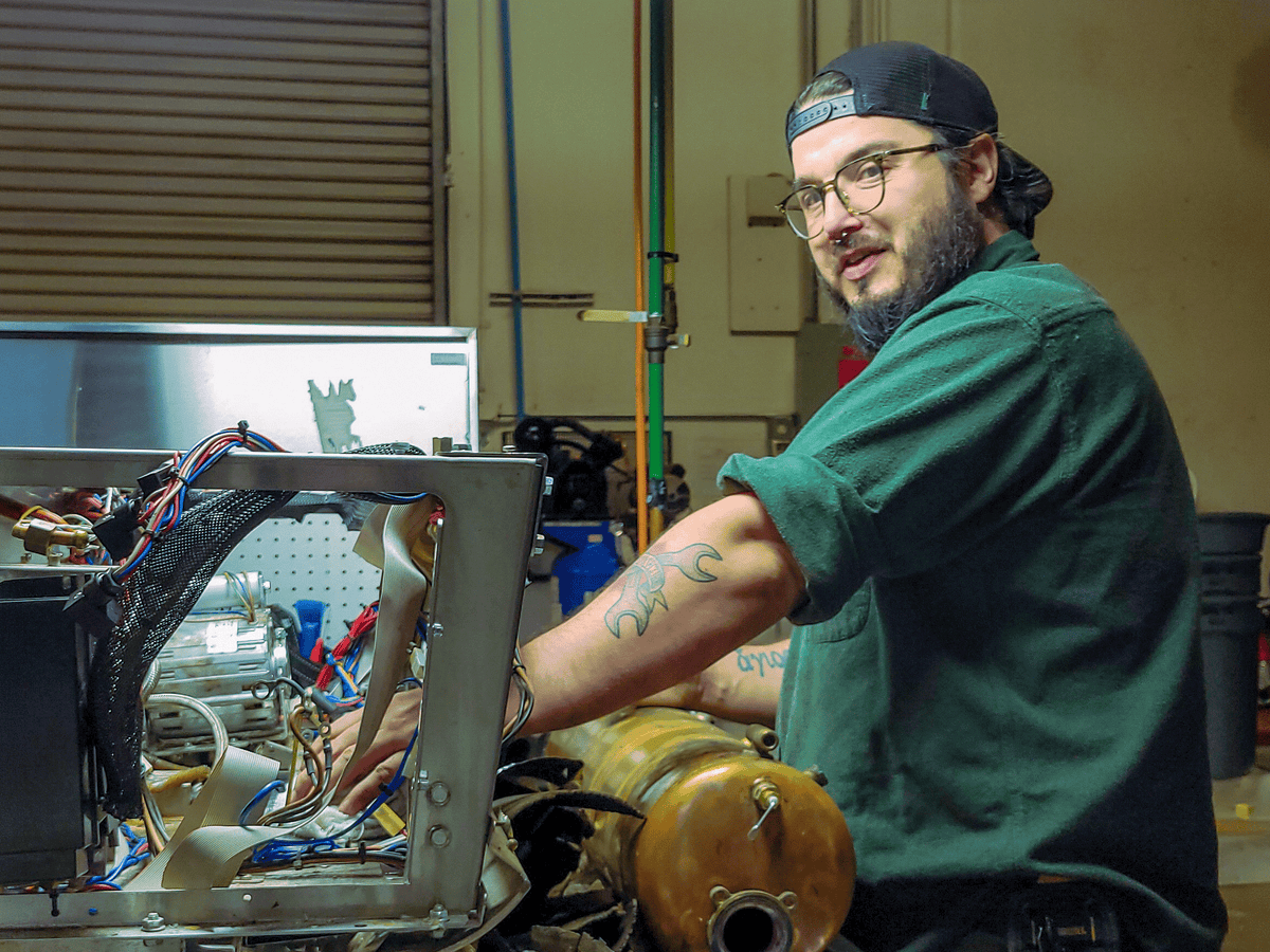 Joshua Klatch Coffees technician working on an espresso machine.