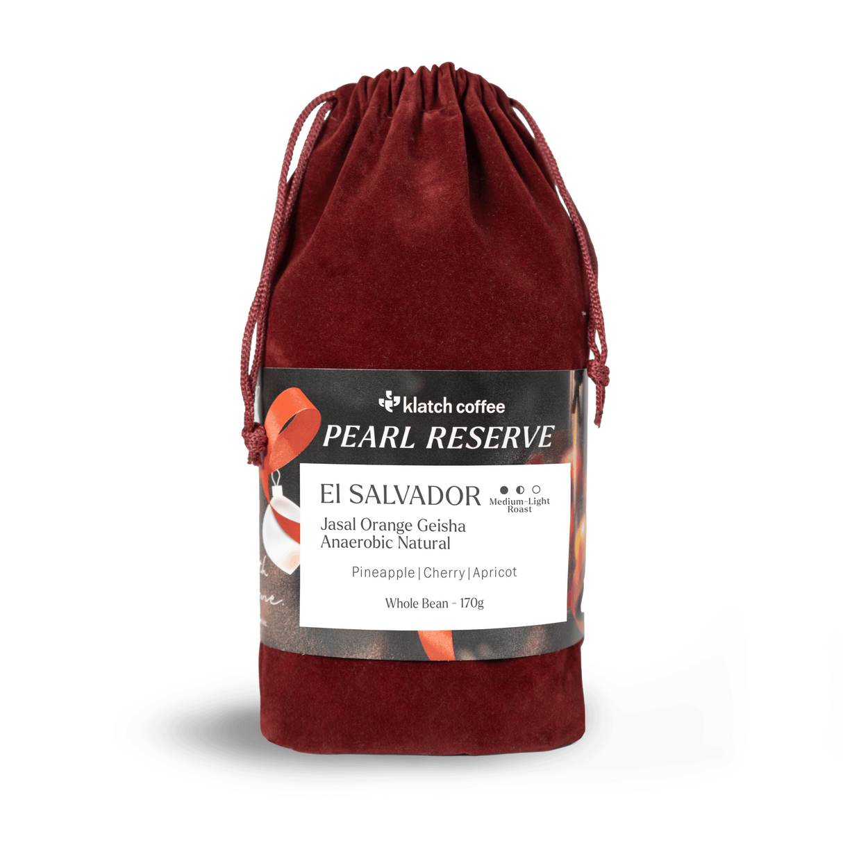 Red velvet drawstring bag with a label on a white background