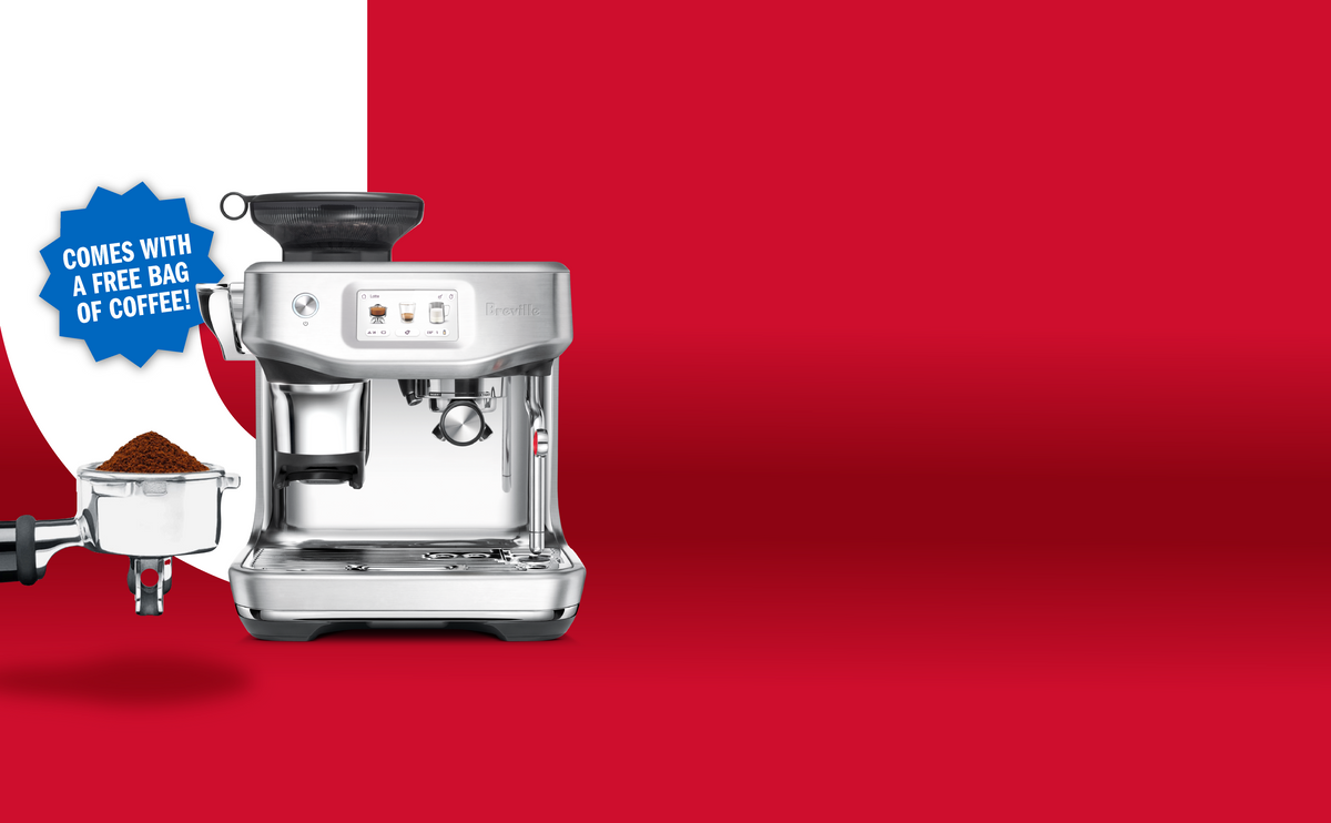 Breville espresso machine with portafilter and milk pitcher on a red and white background, featuring a badge promoting "comes with a free bag of coffee!".