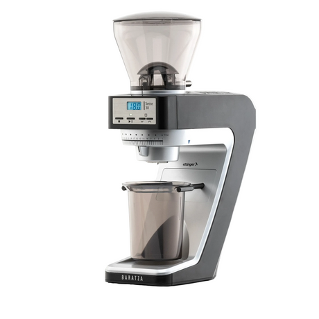 A Baratza espresso grinder with a dark gray and silver body, a clear bean hopper on top, and a clear collection cup below, shown on a solid white background.