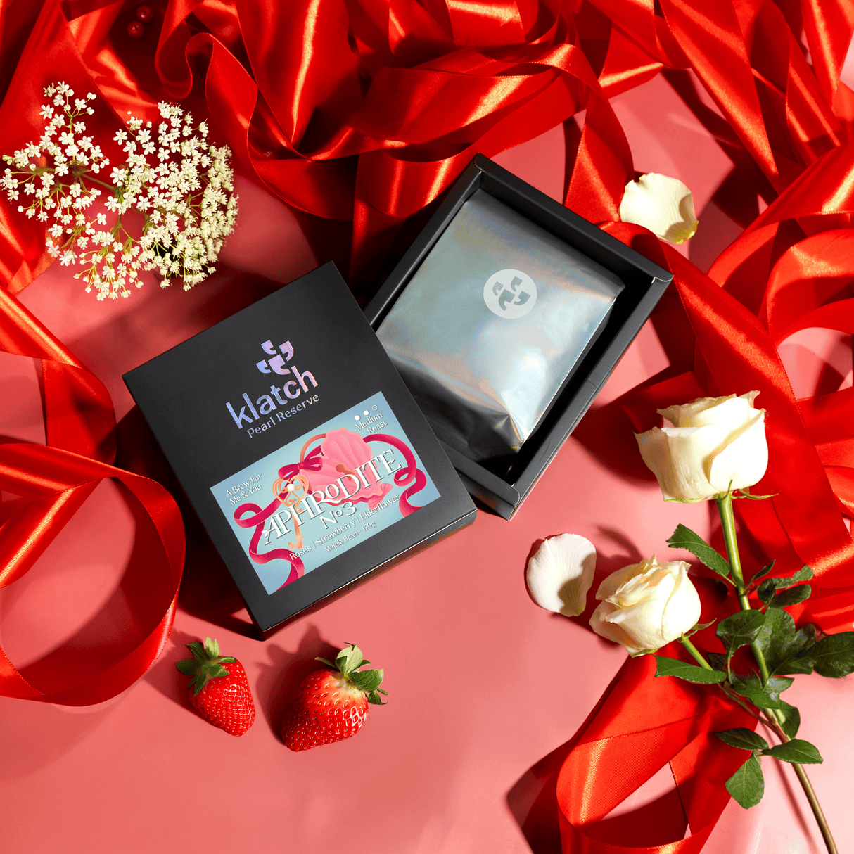 Klatch product packaging on a red background with flowers and ribbons