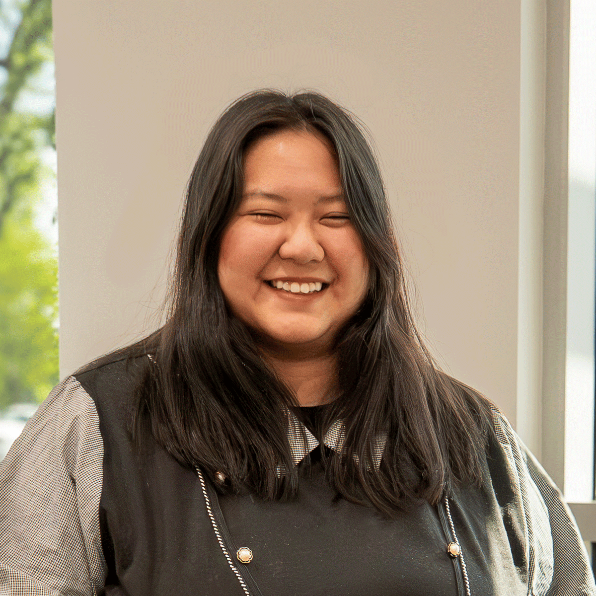 Portrait of Ephney, Klatch Coffee Account Manager, smiling at the camera.
