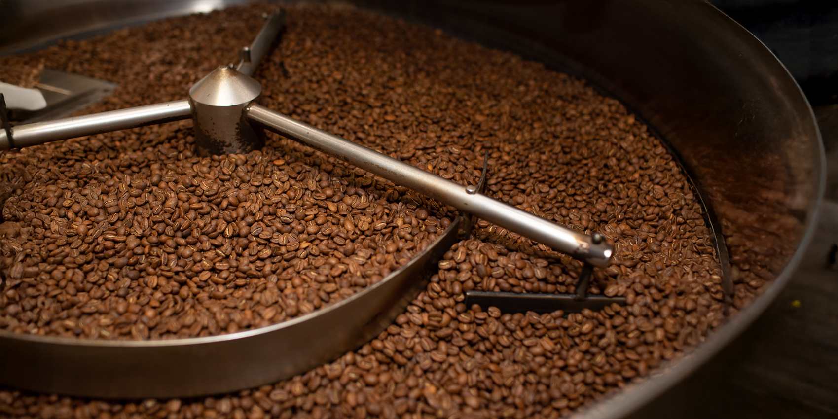 Coffee beans in a roaster being roasted.