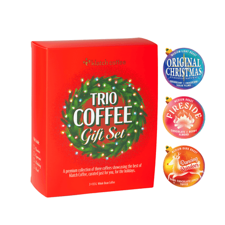 Klatch Coffee Trio Coffee Gift Set in a festive red box featuring a Christmas wreath, with Original Christmas, Fireside, and Dancing Reindeer coffee labels on a white background.
