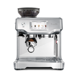 Barista Touch Espresso Machine with coffee grounds in portafilter with digital display on a white background