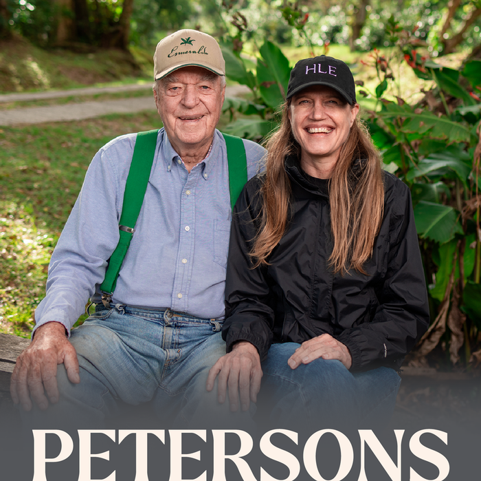 Man and woman sitting next to each other with 'PETERSONS' branded in foreground.