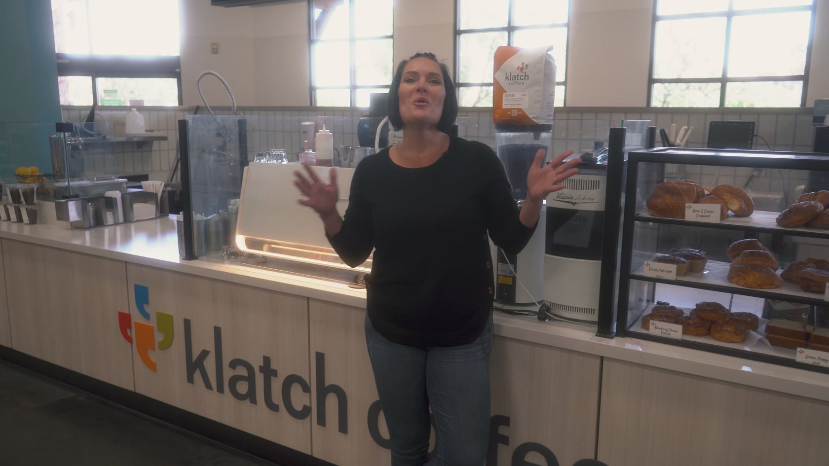 CEO Heather Perry stands in a café setting, discussing National Coffee Day and Klatch Coffee’s expansion.